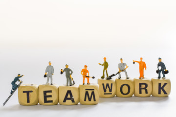 Group of Miniature people, small model human figure standing and climb the ladder on wooden box of word (teamwork). In concept Business success. Copy space for your text.