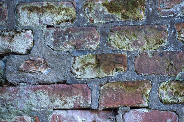 Old brick wall background in Prague. Background of old vintage dirty brick wall with peeling plaster, texture.