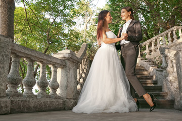 Beautiful lesbian couple on their wedding day outdoors