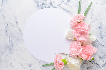 Beautiful flowers and blank card on light background