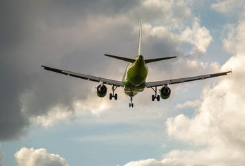 passenger plane flies in thunderclouds in the sky.