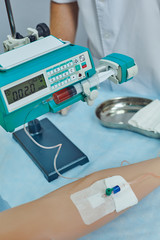 Fototapeta na wymiar Young doctor is practicing medical skills at a medical dummy. Use an infusion pump to infuse medication.