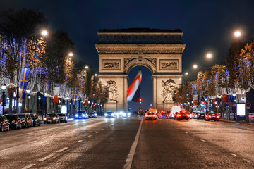 Triumph arc, Arc de Triomphe in French,  place at the blue hours crowded with car traffic, Paris,...