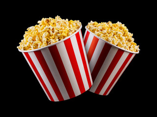 Set of paper striped buckets with popcorn isolated on black background