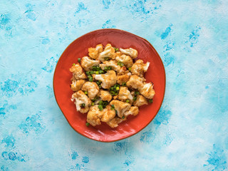 Cauliflower fried on a plate. Top view.