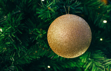 golden christmas ball on green background