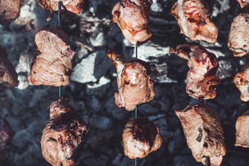 Marinated meat pork being put on barbecue brazier. Cooking meat on the fire concept.