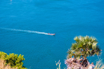 A long tail boat at the sea with the blue sea