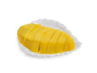 Close-up delicious ripe yellow mango in white plate isolated on white background.