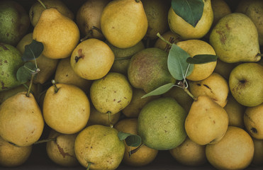 Organic ripe pears in a box, close up. Harvesting pears. Top view.