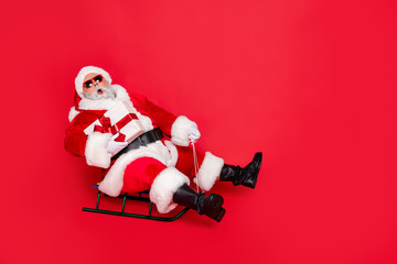 Full length body size view of amazed stunned kind funky fat overweight plump gray-haired bearded man sledging carrying bow ribbon purchase isolated over bright vivid shine red background
