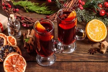 Christmas hot mulled wine with cinnamon cardamom and anise on wooden background