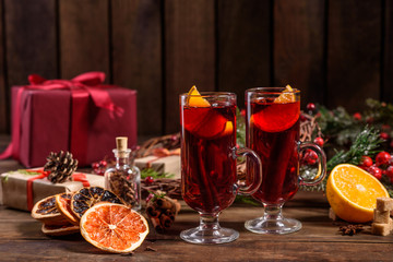 Christmas hot mulled wine with cinnamon cardamom and anise on wooden background