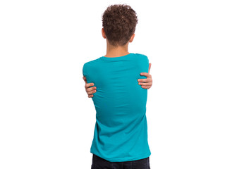 Back view. Self love and self care. Portrait of teen boy Hugging oneself, isolated on white...