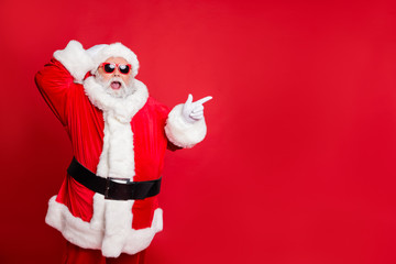Fototapeta na wymiar Portrait of his he nice attractive cheerful cheery glad stunned bearded Santa showing ad advert copy space present gift surprise isolated over bright vivid shine red background