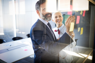 Successful team leader and business owner leading informal in-house business meeting