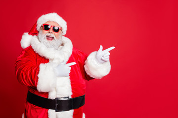 Fototapeta na wymiar Portrait of his he cheerful cheery funky fat overweight plump gray-haired bearded man pointing choose choice decision gift present surprise isolated over bright vivid shine red background