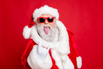 Close-up portrait of his he confident crazy naughty fat overweight plump gray-haired bearded man having fun showing horn symbol rock roll heavy metal isolated over bright vivid shine red background