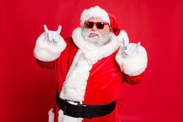 Close-up portrait of his he confident naughty fat overweight plump gray-haired bearded man having fun time showing horn sign symbol rock roll isolated over bright vivid shine red background