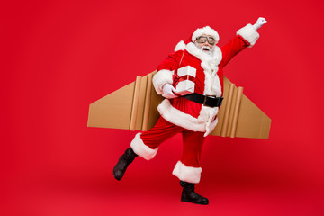 Full length profile side photo of crazy funny elderly superhero santa start launch fly up his...