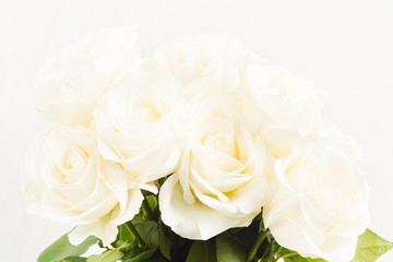 Closeup view of white roses in bouquet on white background