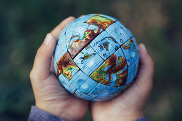 Small Hands holding the world in Vintage style.