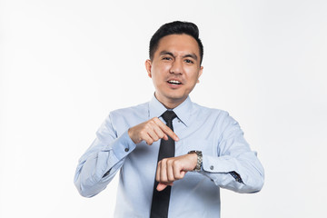 Asian man pointing at his wrist watch