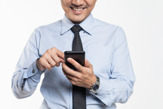 Asian man in office wear looking at his handphone with being success expression