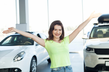 businesswoman giving key at automotive showroom