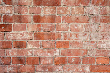 old brick wall of bricks of different colours closeup.