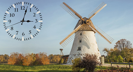 Fallback time. Abstract photo with windmill and Autumn landscape. Time change concept.