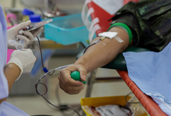 Blood donor at donation with a bouncy ball holding in hand, image for Thailand Aug 2019.