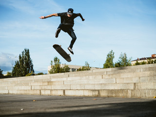 Fototapeta na wymiar Skateboarder doing a trick on the skateboard