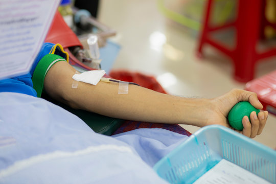 Blood donor at donation with a bouncy ball holding in hand, image for Thailand Aug 2019.