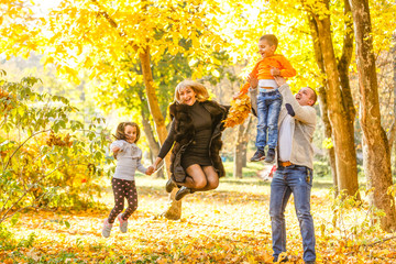 family with two children in autumn park