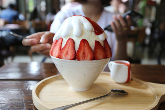 Closeup of strawberry bingzu with milk snow ice on the table in restaurant
