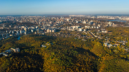 Golden autumn background, aerial drone view of forest with yellow trees and beautiful lake landscape from above, Kiev, Goloseevo forest, Ukraine