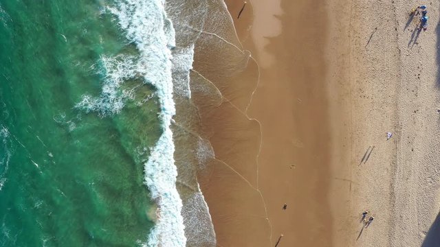 Top down shot of people playing on the beach in Sydney Australia