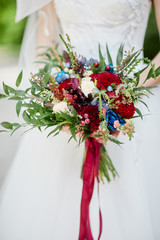 bride holds a wedding bouquet in her hands
