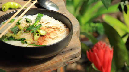 Instant Ramen Noodles in a Cup with vegetables, peppers and lemons
