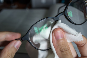 wiping glasses with microfiber cloth