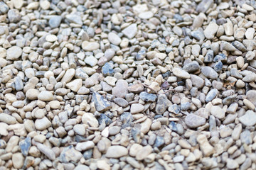 Fototapeta na wymiar River or sea stone background. Set of all kinds of stones. Part of image is blurred.