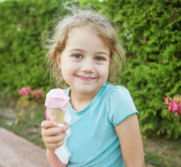 cute smiling little girl eating ice cream