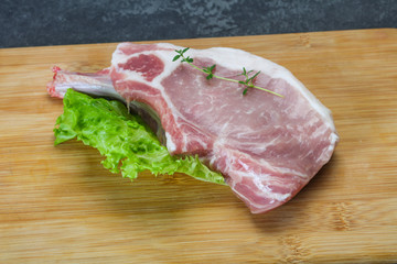 Raw pork bone steak over wooden