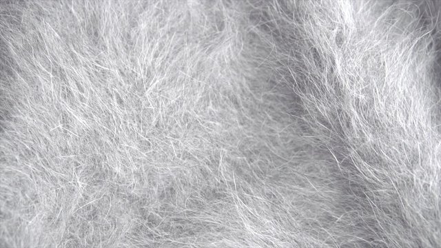 Soft wool grey background. Alpaca gray wool mohair clothes texture closeup. Natural cashmere fluffy merino wool. Woolen fabric. Rotated. 4K UHD video footage. 3840X2160