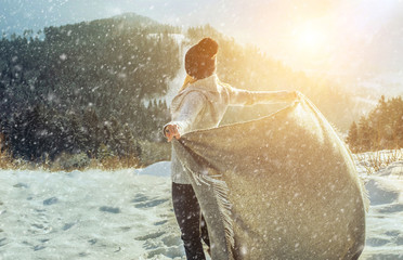 Happy woman traveler on the snowy of mountain look on the nice w