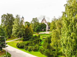 Naklejka premium Hollola, Finland - 9 September 2019: Aerial view of old medieval stone church of St. Mary in Hollola, Finland