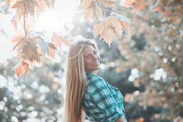 Young woman enjoying in autumn colored nature.