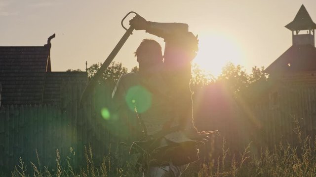 Silhouette of a knight practicing using the sword for battle.