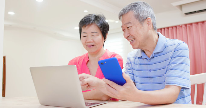 elder couple use smart phone